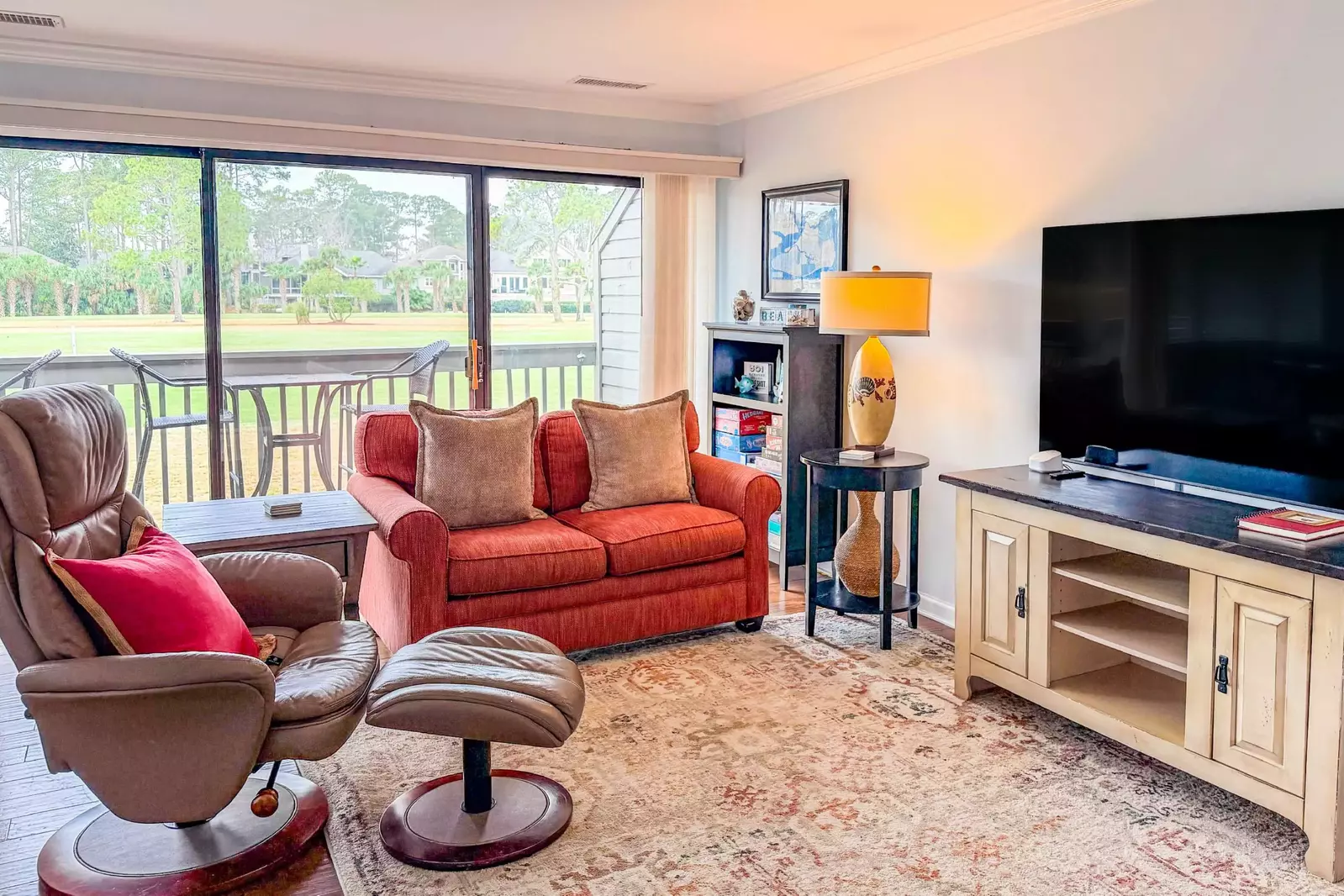 The living room receives wonderful natural light through the sliding glass doors.