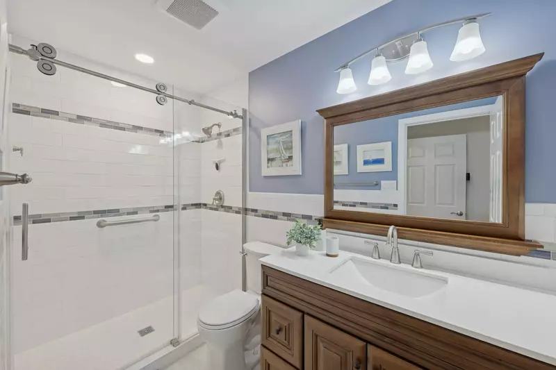 Primary Suite's en suite bath with beautiful tile work and great counter space