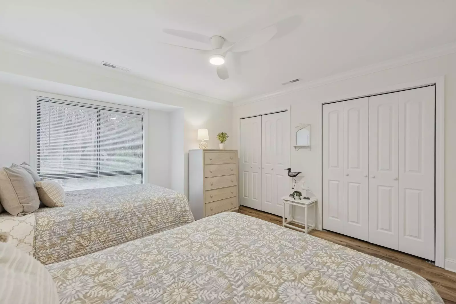 Guest bedroom with natural light, ceiling fan and plenty of closet space