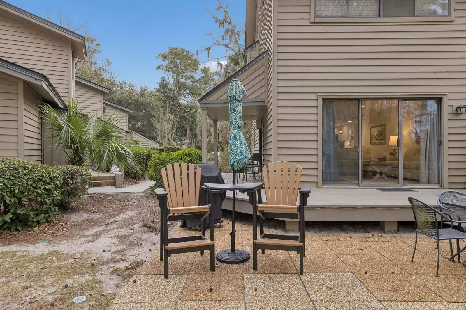 Back living space with hightop chairs and umbrella