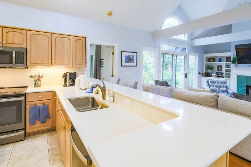 The kitchen features a dishwasher, range, microwave and drip coffee maker.