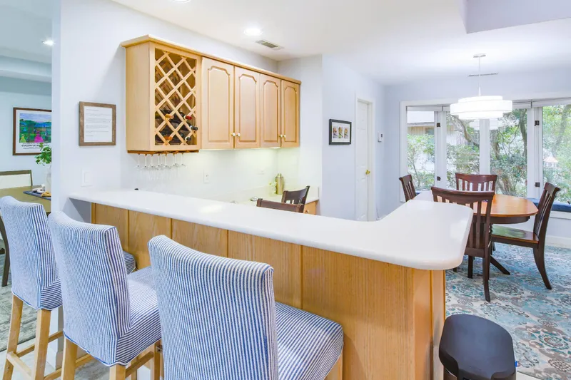 There are dining tables in the kitchen and in the separate dining room.