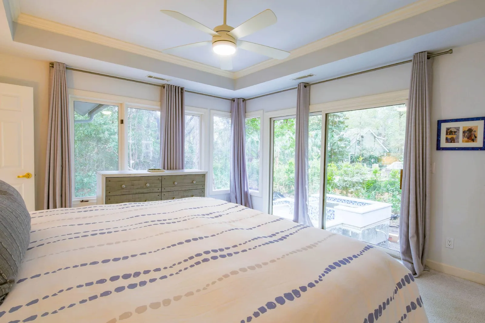 The primary suite looks out onto the new private pool & hot tub in the backyard.