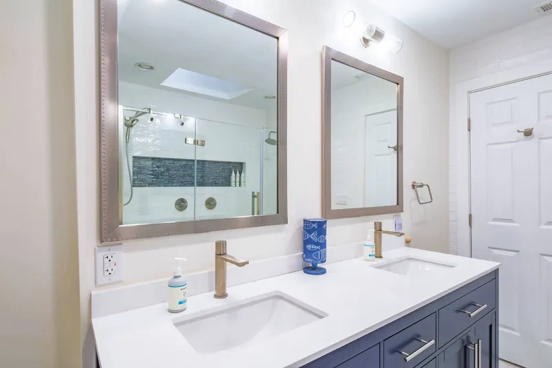 The en suite bathroom features a dual sink vanity.