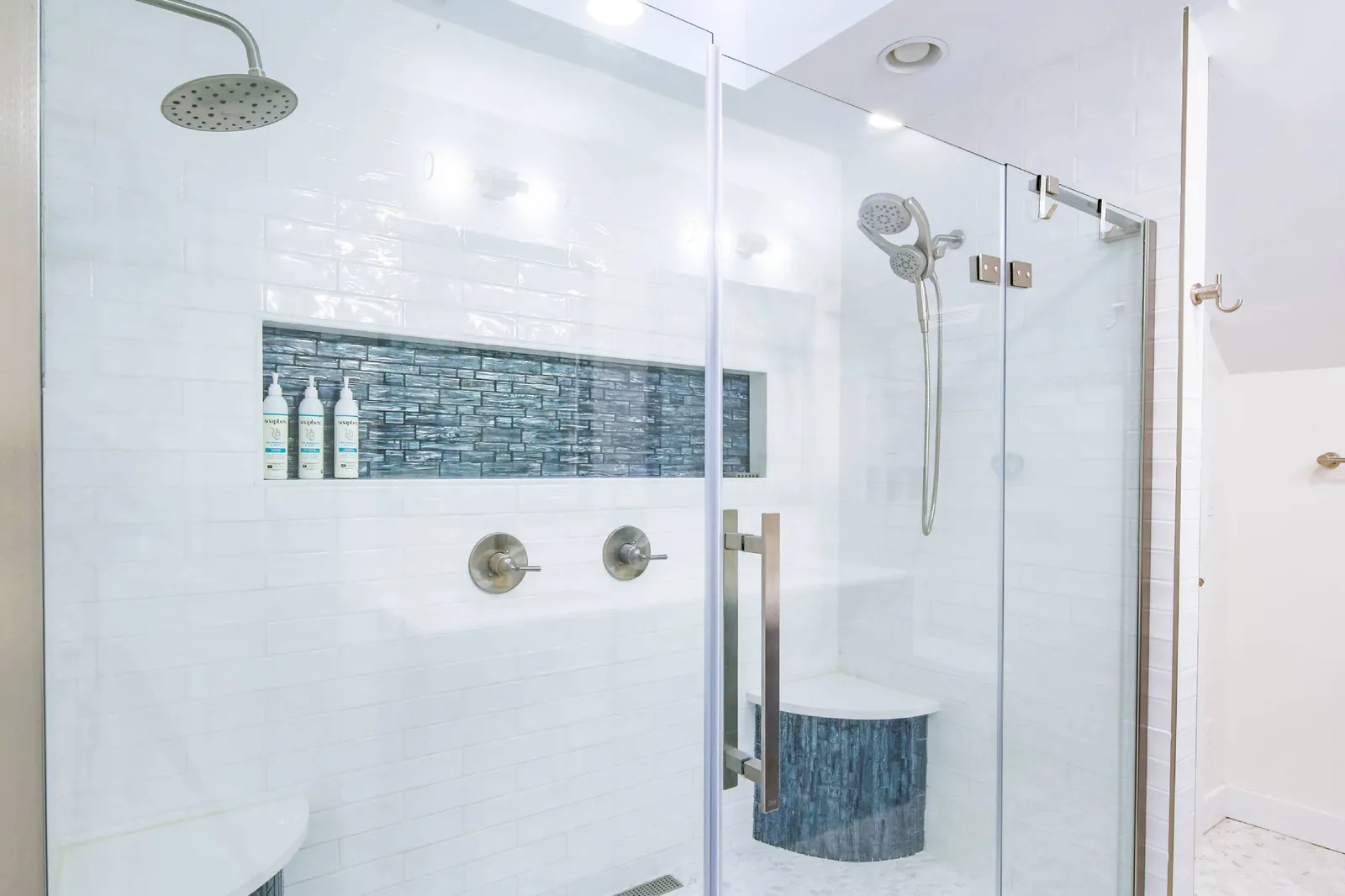 This en suite bathroom also has a beautifully tiled, walk-in shower with two shower heads.