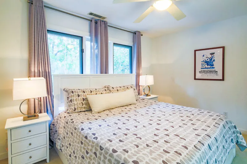 The Jack bedroom features a king bed, night stands with lamps and a ceiling fan.