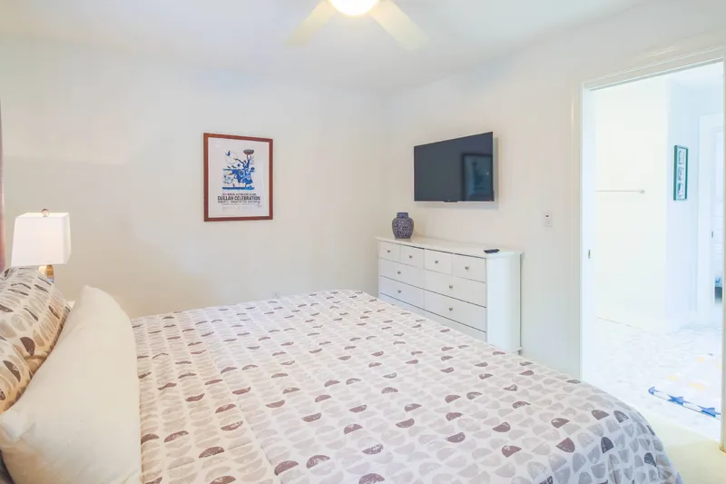 The Jack bedroom also features a dresser and wall-mounted smart TV.