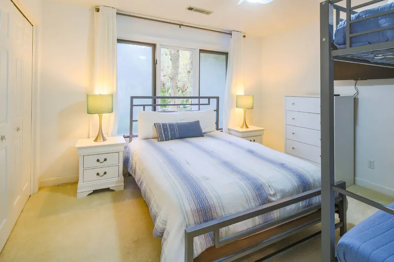 The Jill bedroom features a queen bed with night stands, lamps and a dresser.