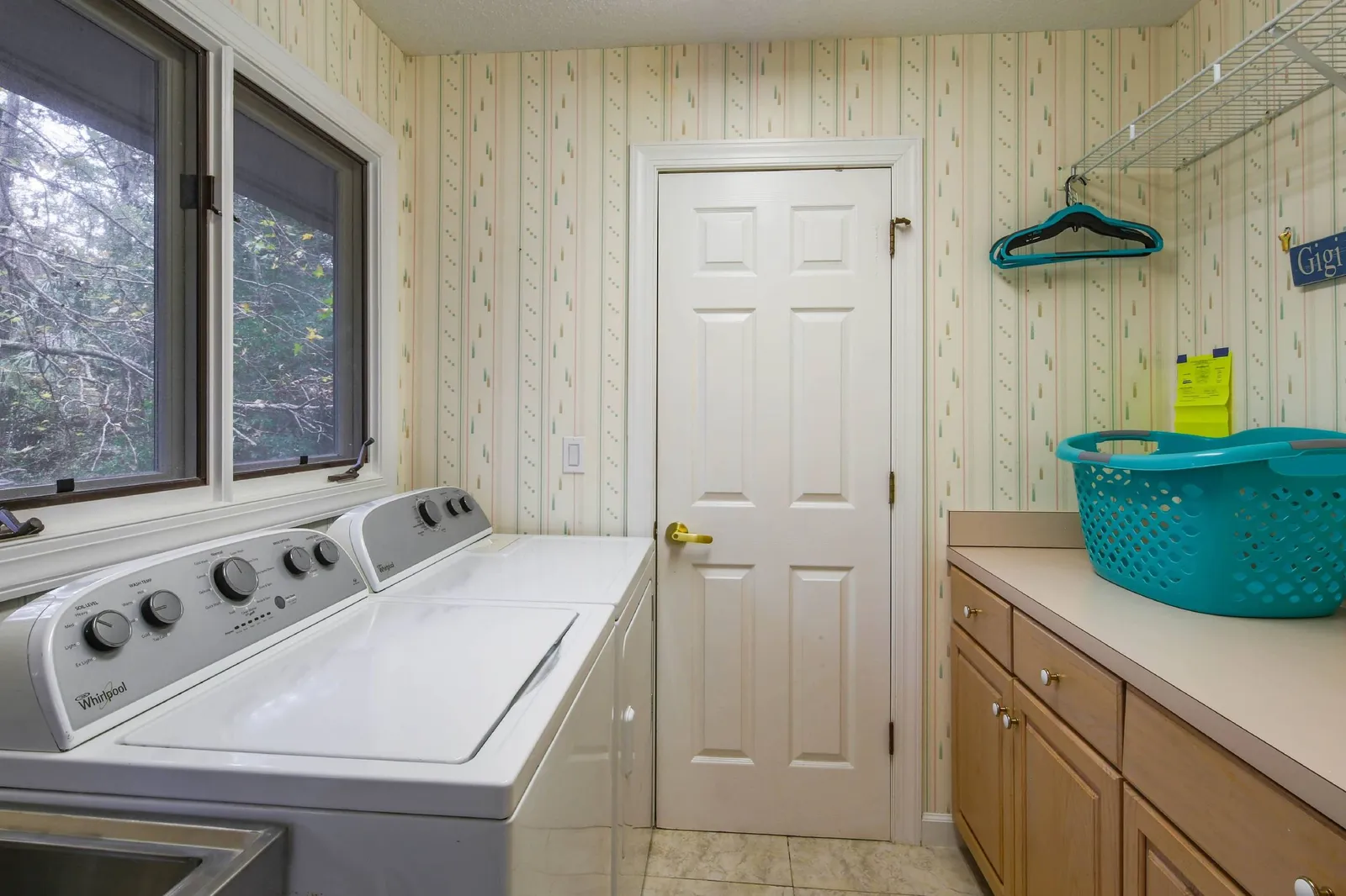 The laundry room features a washing machine, dryer and counter.