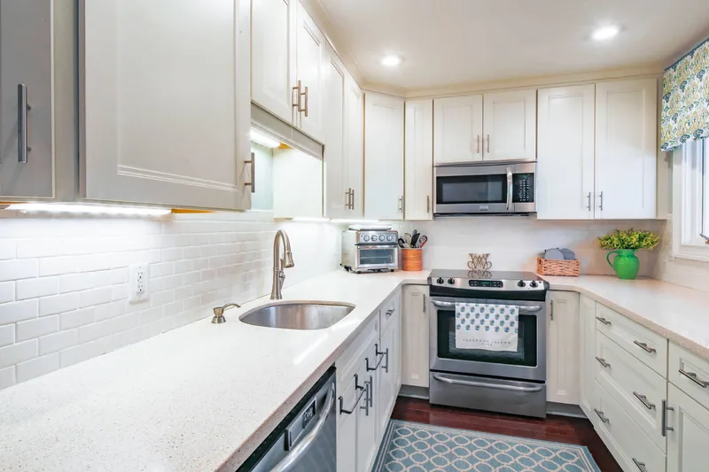 The kitchen features a dishwasher, electric range, microwave and airfyer/toaster oven.