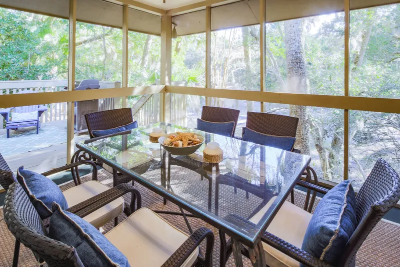 The live oak trees behind the villa provide sun-dappled shade and peaceful views.