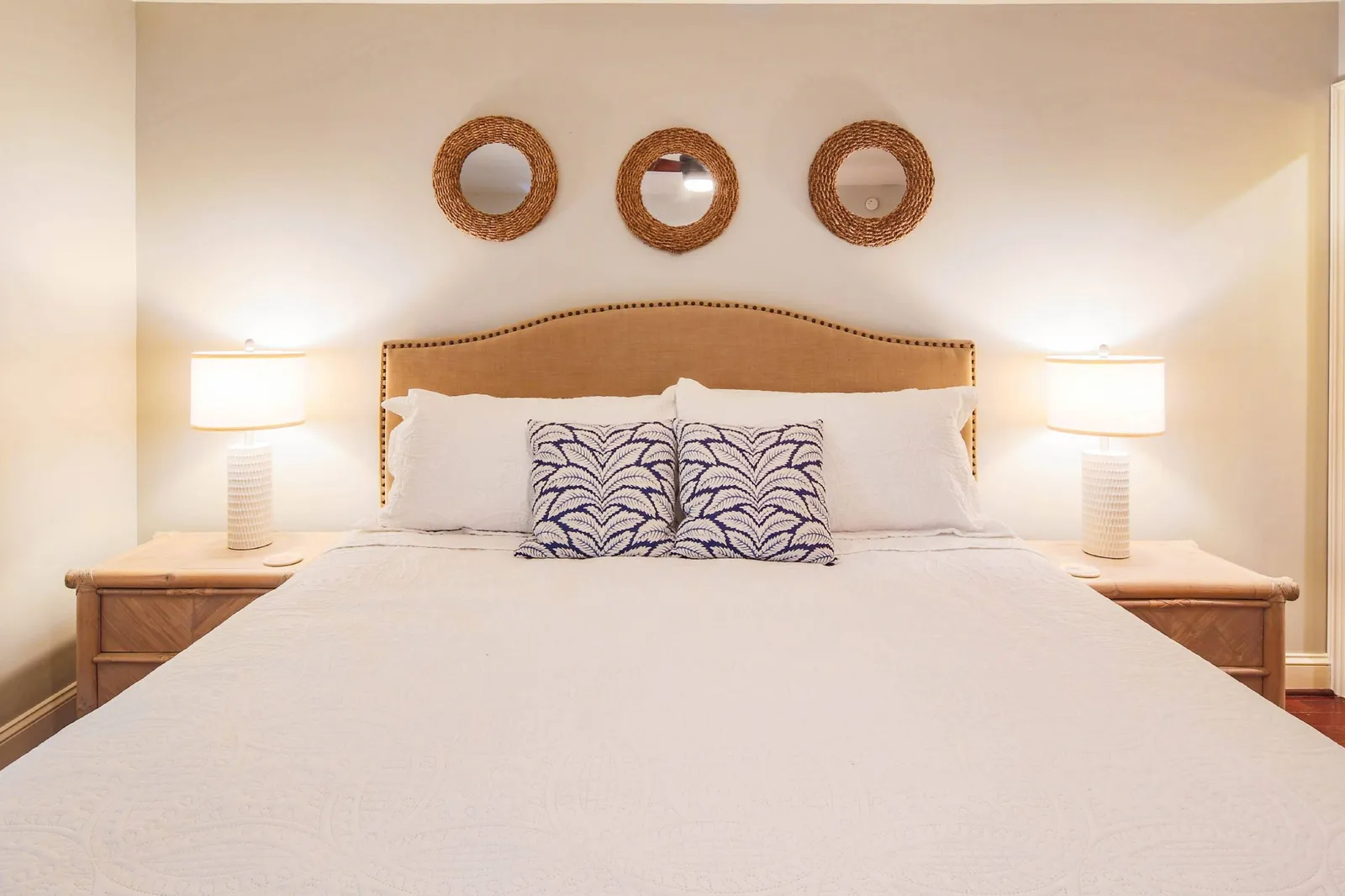 The primary suite features a king bed and night stands with reading lamps.
