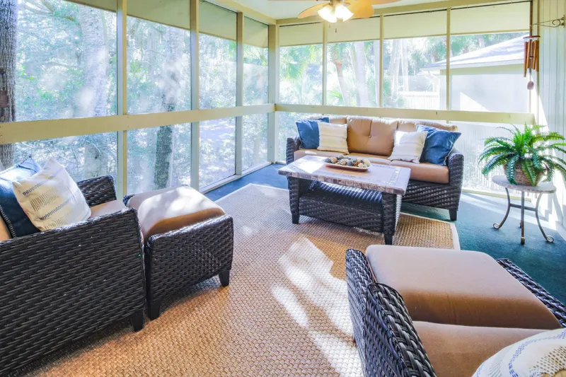 This comfy seating area on the screened porch is the perfect spot for morning coffee or evening beverages.