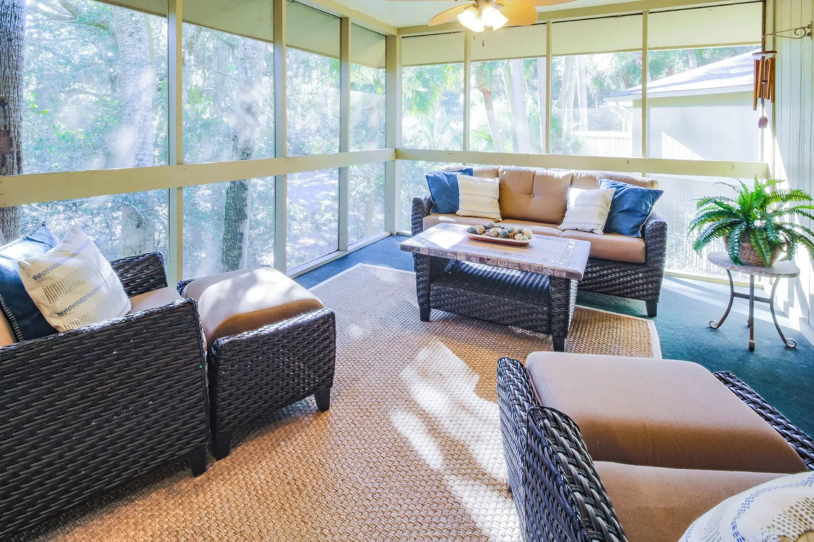 This comfy seating area on the screened porch is the perfect spot for morning coffee or evening beverages.
