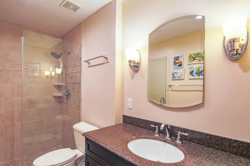 The en suite bathroom for the primary suite features a spacious vanity.