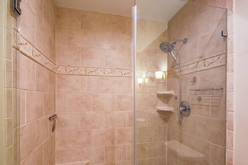 The primary en suite bathroom also features a tiled, walk-in shower.