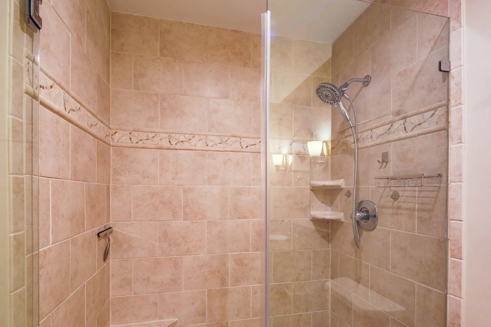 The primary en suite bathroom also features a tiled, walk-in shower.