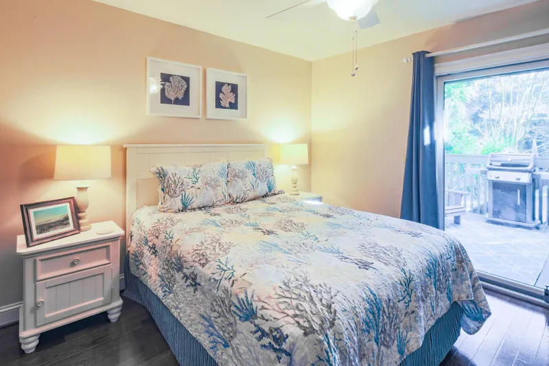 The queen bedroom features a queen bed and night stand with reading lamps.