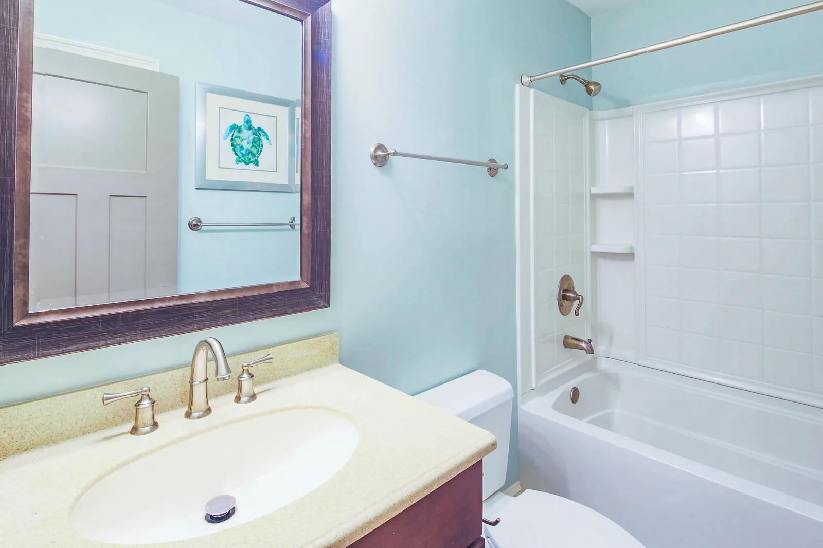 The hallway bathroom features a vanity and shower/tub combo.