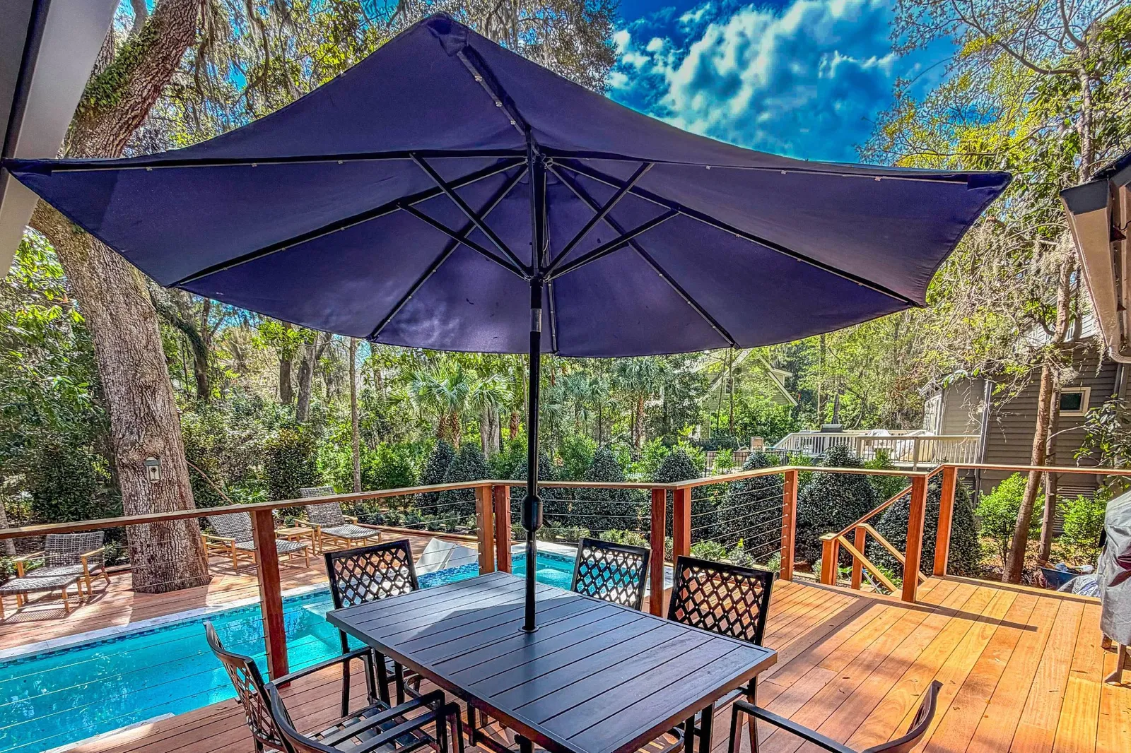 The back deck features an outdoor dining table and chairs.