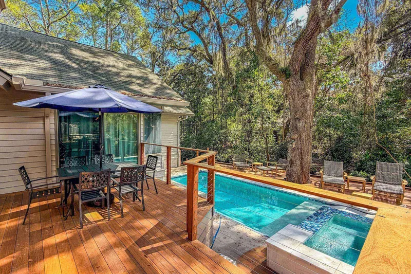 The private pool and hot tub are just steps down from the back deck.