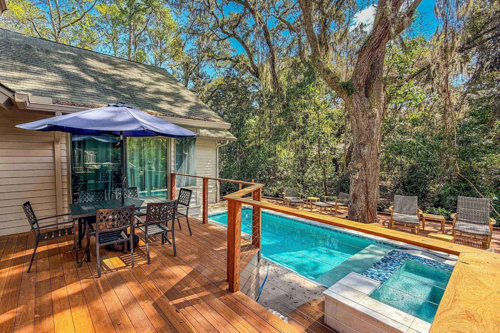The private pool and hot tub are just steps down from the back deck.