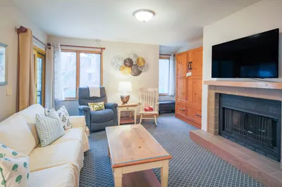 There is a custom-built queen Murphy bed in the brown cabinet in the living room.
