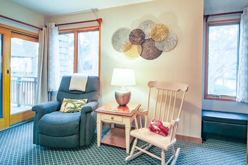 The seating area in the living room includes a rocking chair and recliner.