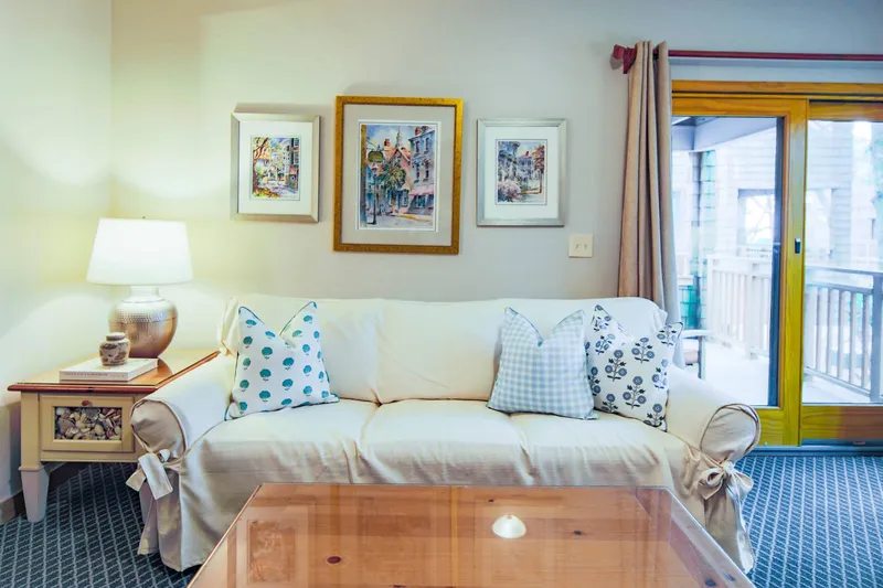 The sliding door near the living room sofa leads to the covered balcony.