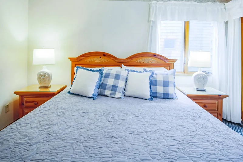 The bedroom features a king bed and night stands with reading lamps.
