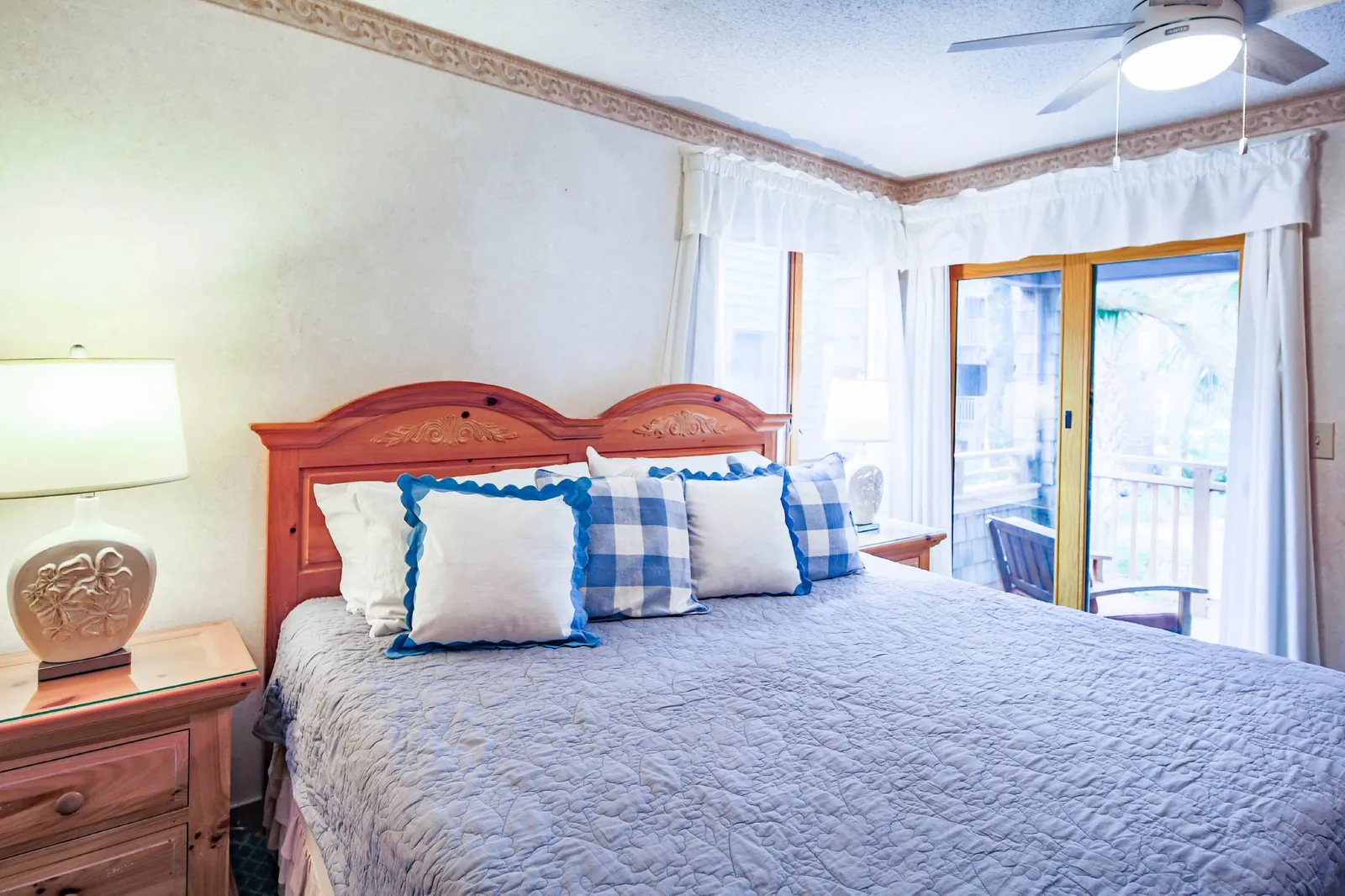 The bedroom features sliding door access to a covered balcony.