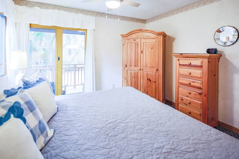 The bedroom also has an armoire, dresser and ceiling fan.