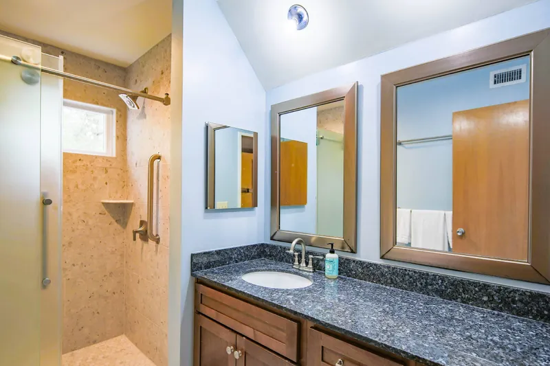 The renovated bathroom is located just outside the bedroom.