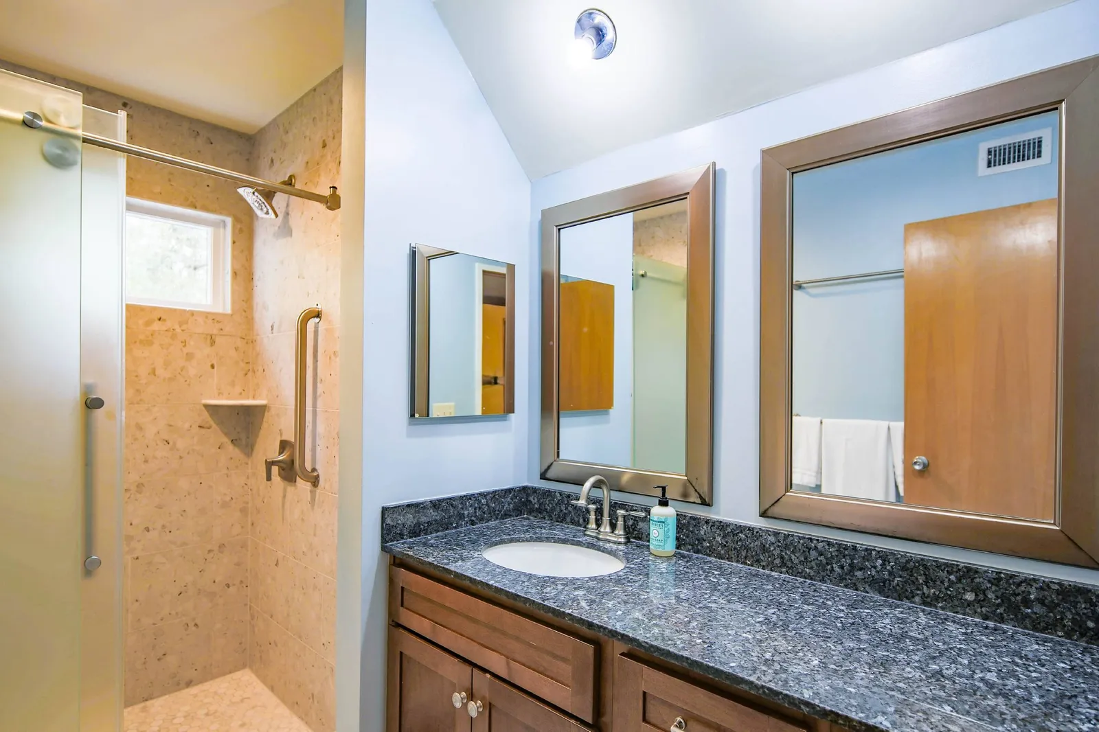 The renovated bathroom is located just outside the bedroom.