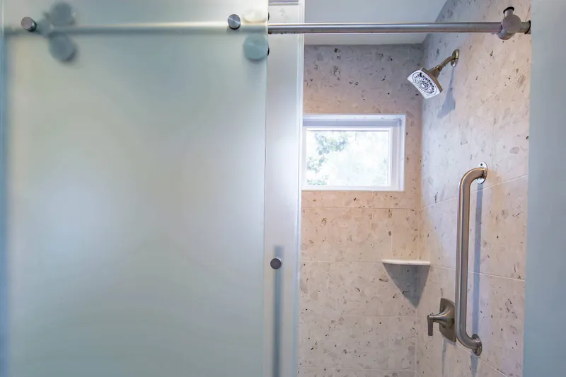 The bathroom also features a tiled, walk-in shower.