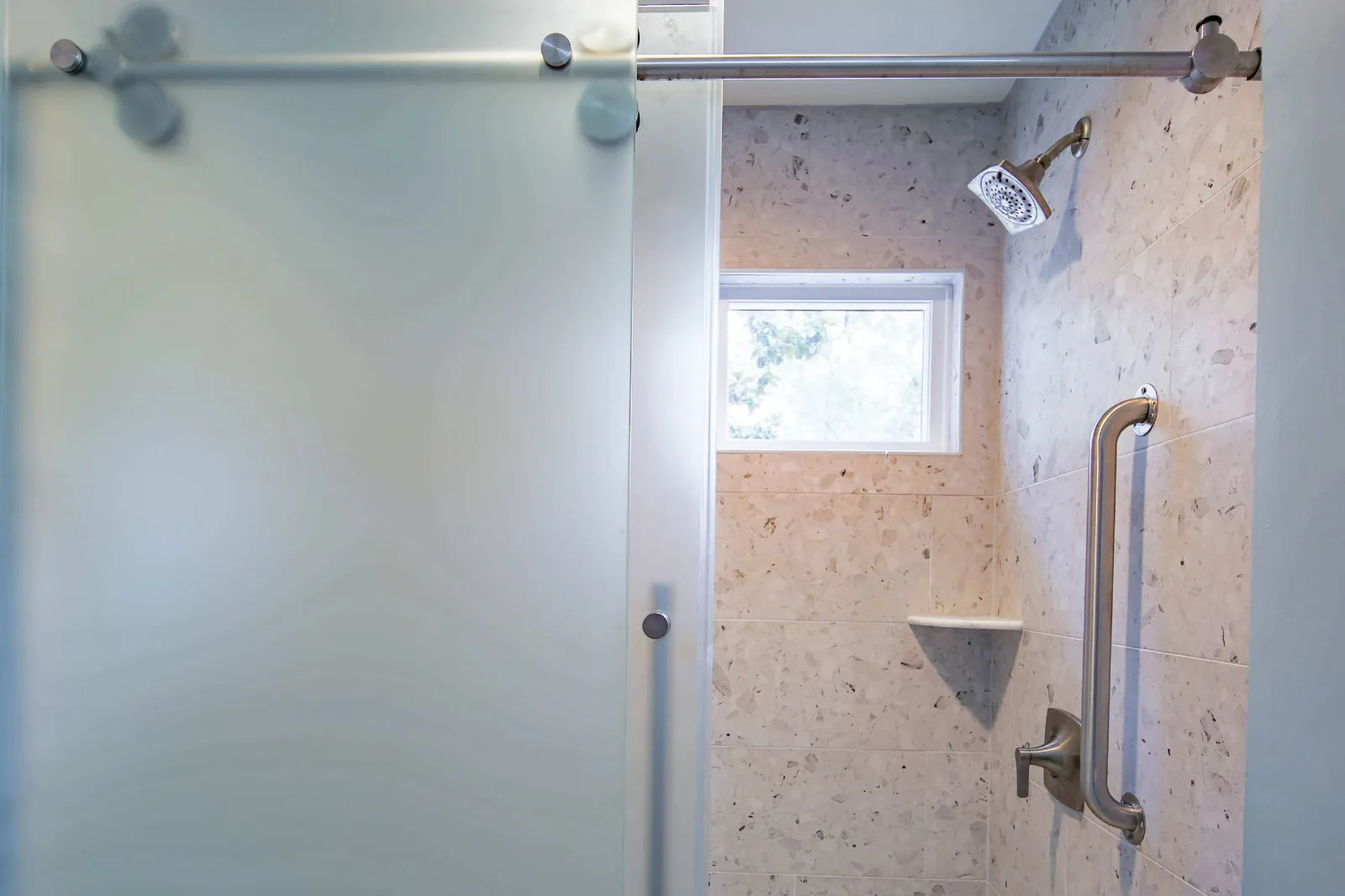 The bathroom also features a tiled, walk-in shower.