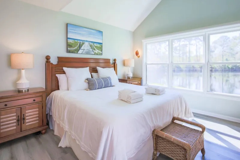 The primary suite features lagoon views and lovely natural light.