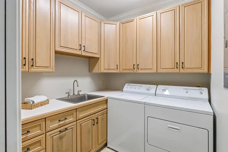 The large laundry room with full size washer and dryer