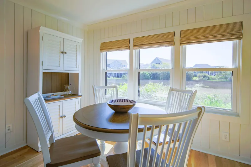 This serene villa features shiplap walls, hardwood floors and a comfortable coastal decor.