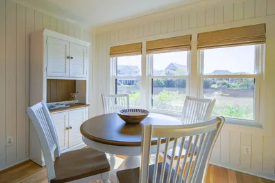 This serene villa features shiplap walls, hardwood floors and a comfortable coastal decor.