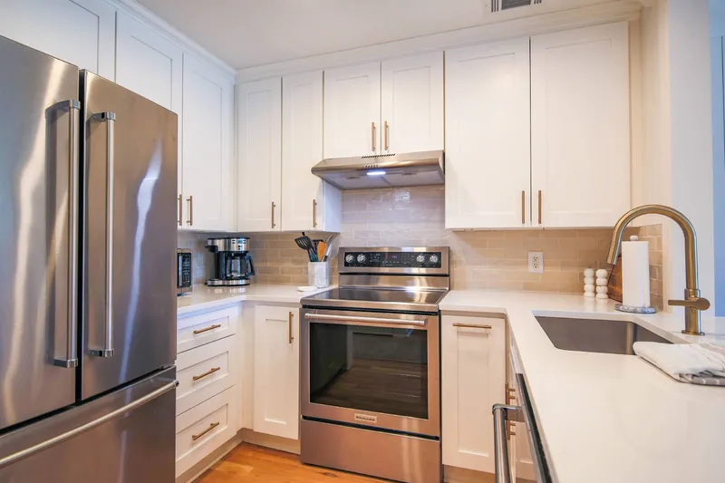 The kitchen has a refrigerator, microwave, drip coffee maker, range and dishwasher.