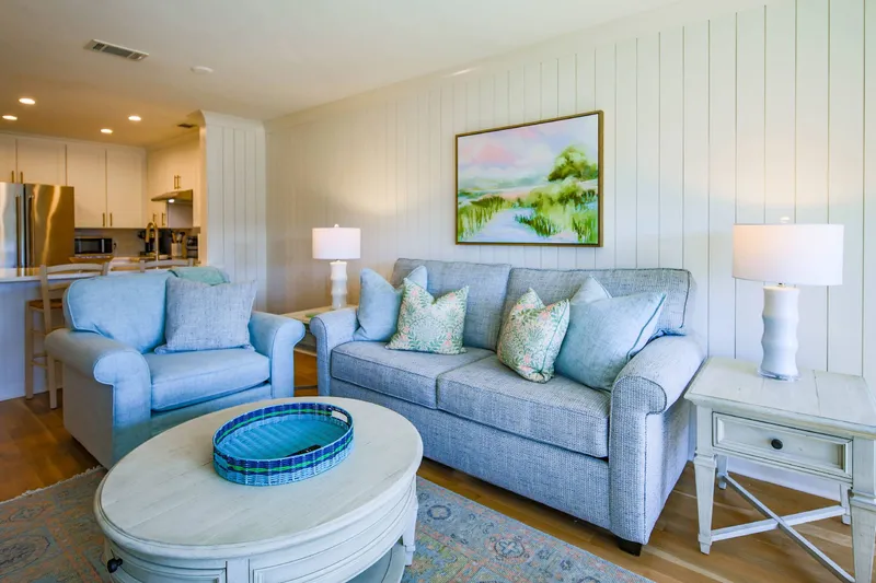 The sofa in the living room is a queen sleeper sofa bed.