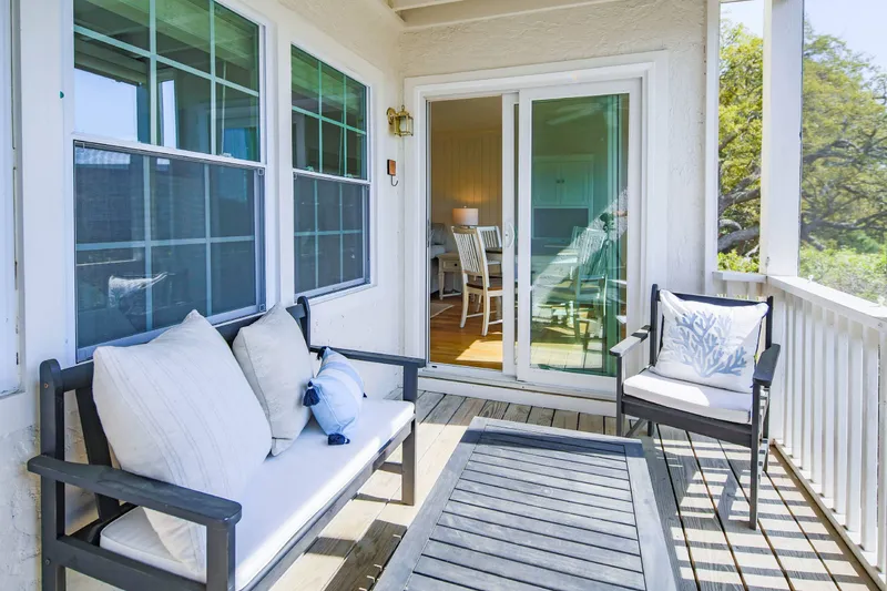 The screened porch features an outdoor seating area. This is the perfect spot for your morning coffee!