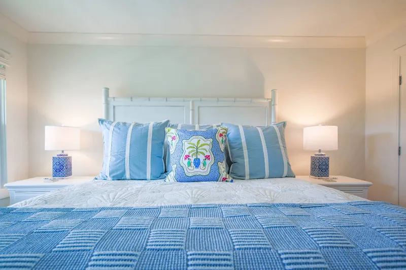 The bedroom features a king bed and two night stands with reading lamps.