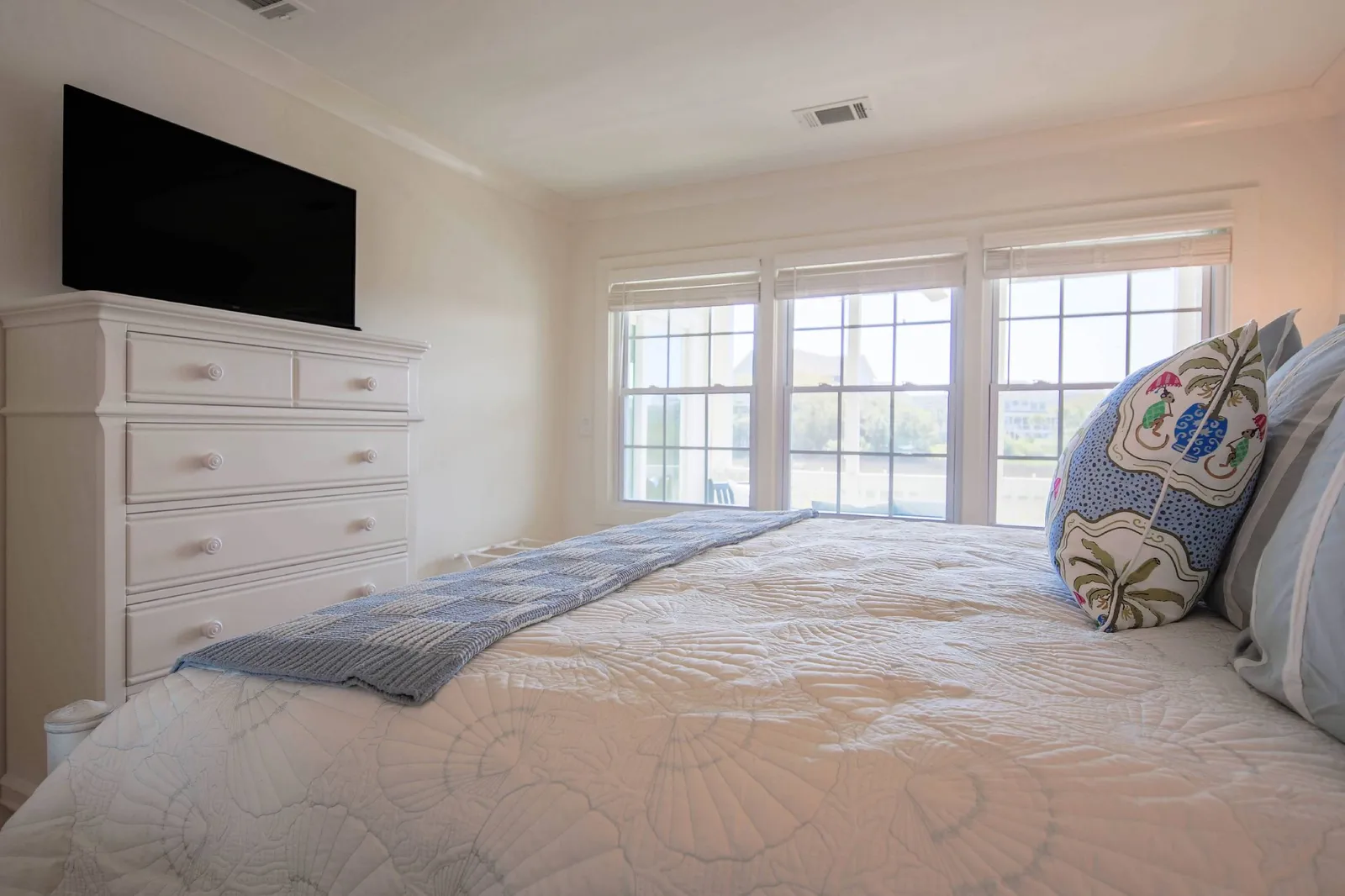 The bedroom looks out onto the screened porch and marsh.
