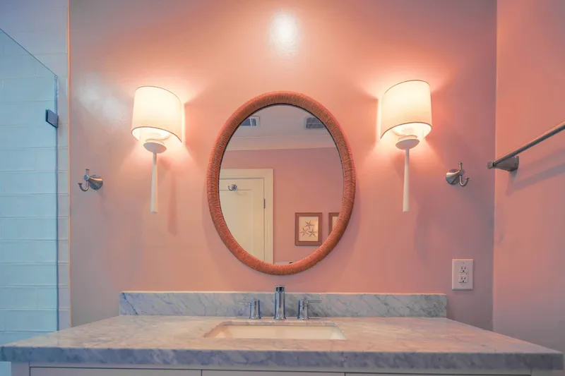 The bathroom features a spacious vanity with wall sconces.