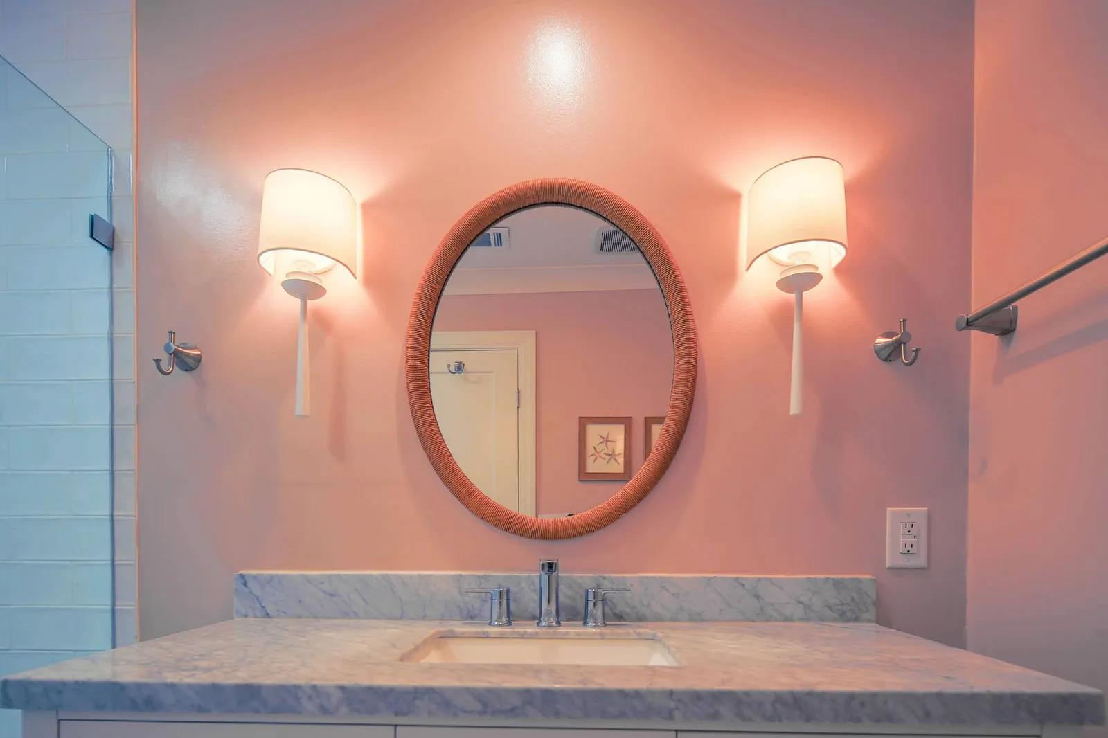 The bathroom features a spacious vanity with wall sconces.