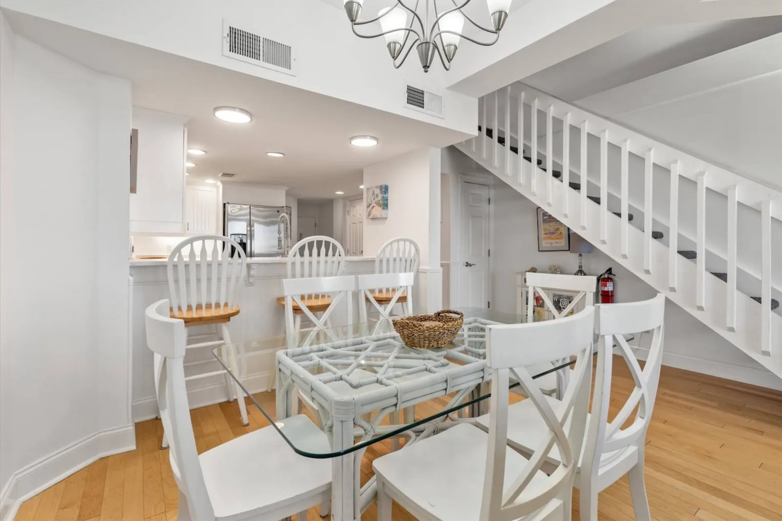 The dining table seats 6 and there are 3 stools at the kitchen counter.