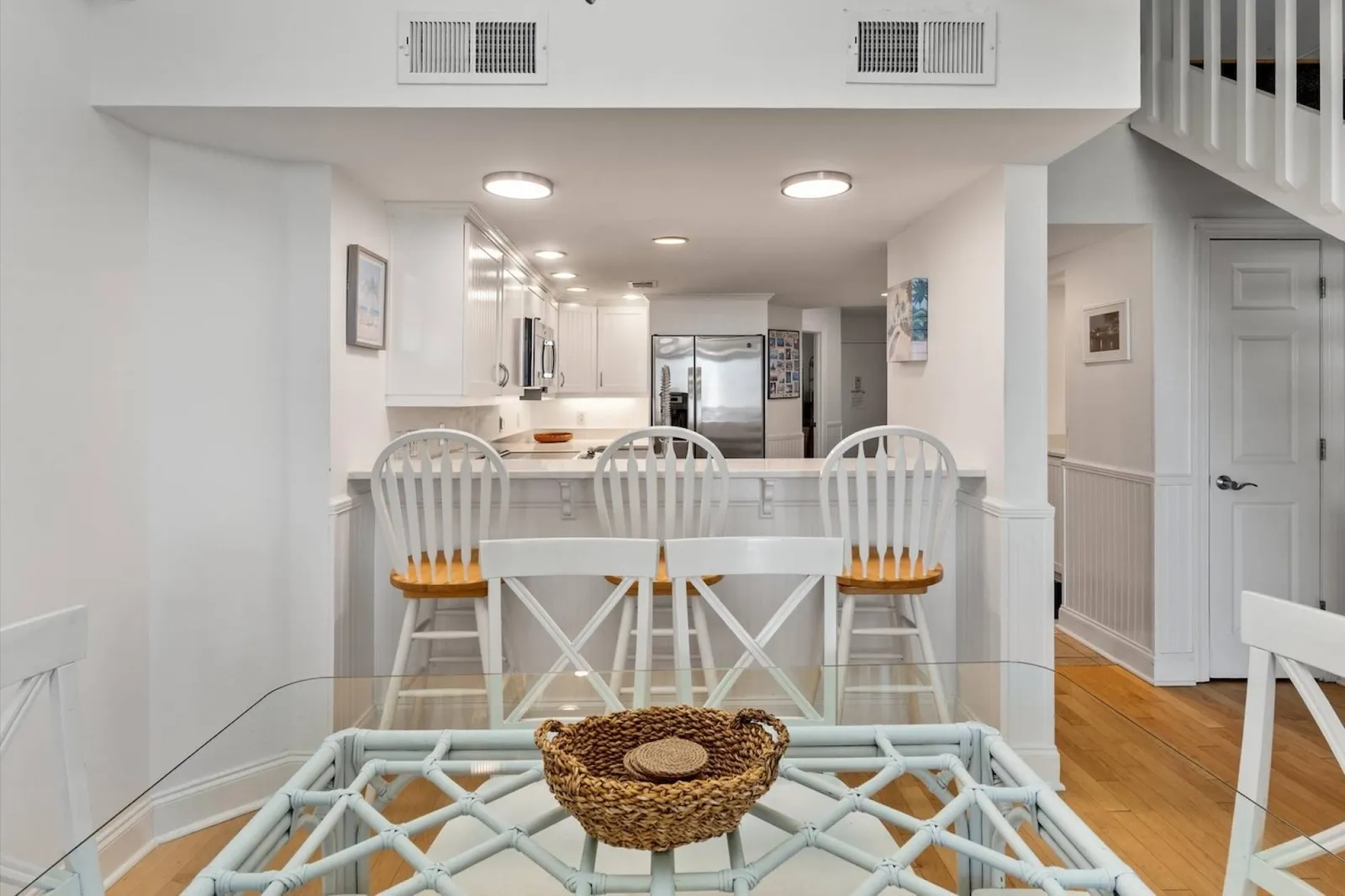 The white walls, trimwork, cabinets and furniture create a clean, coastal feel.