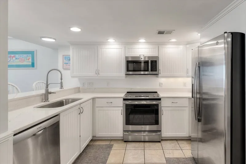 The kitchen has a refrigerator, range, microwave and dishwasher.